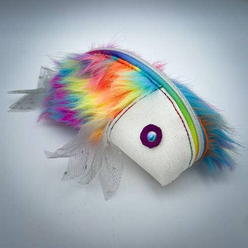 A zippered pouch sewn with white glitter faux leather, rainbow faux fur, and iridescent sequin tulle.